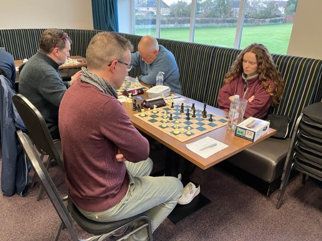 A group of people playing chess

Description automatically generated
