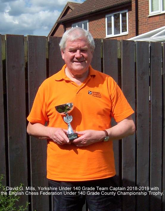A person holding a trophy

Description automatically generated